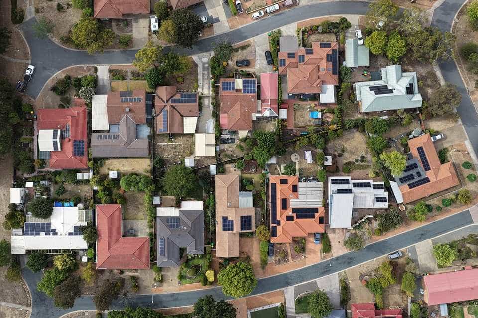 Aerial view of a Canberra suburb with solar panels on many house roofs