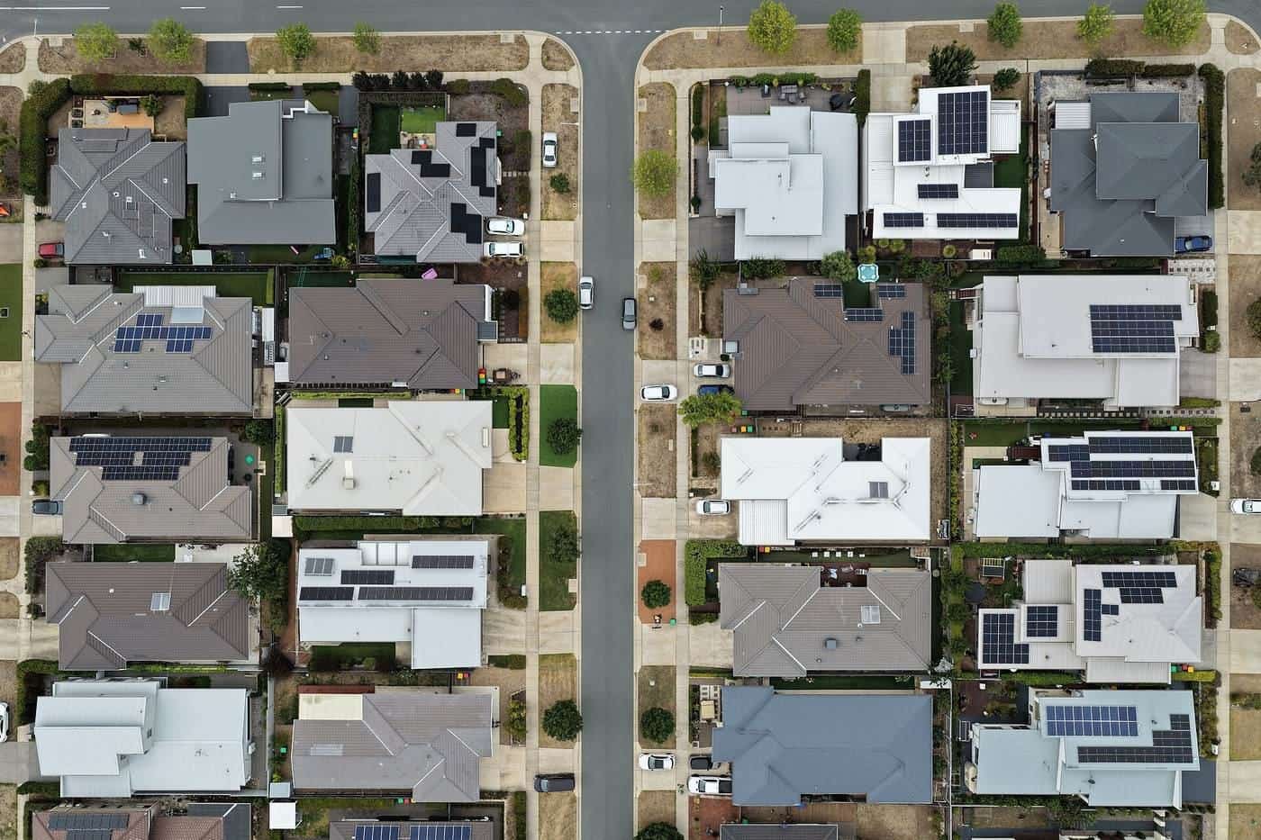Aerial view of suburban streets with solar panels on many roofs