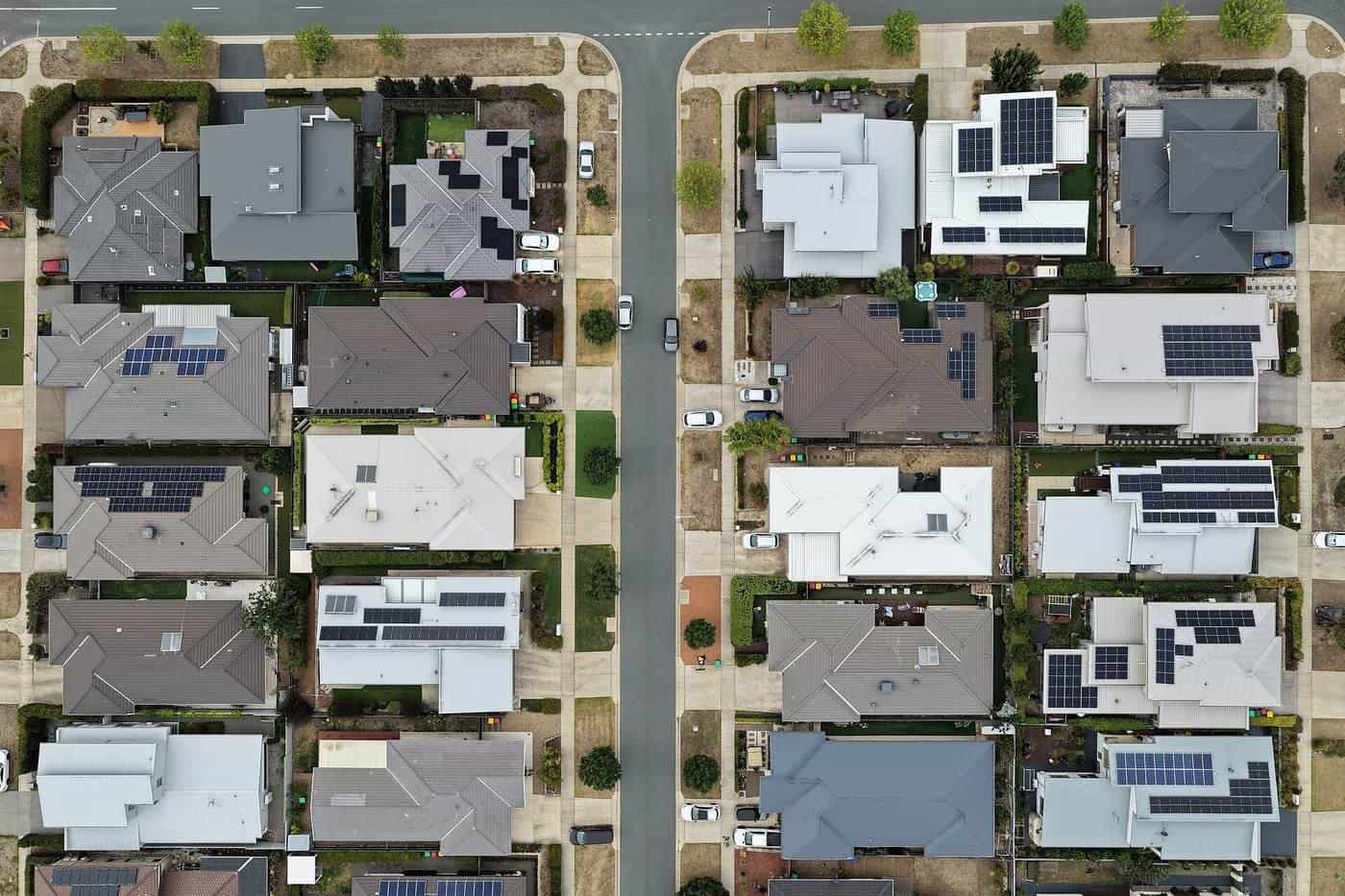 Aerial view of suburban streets with solar panels on many roofs