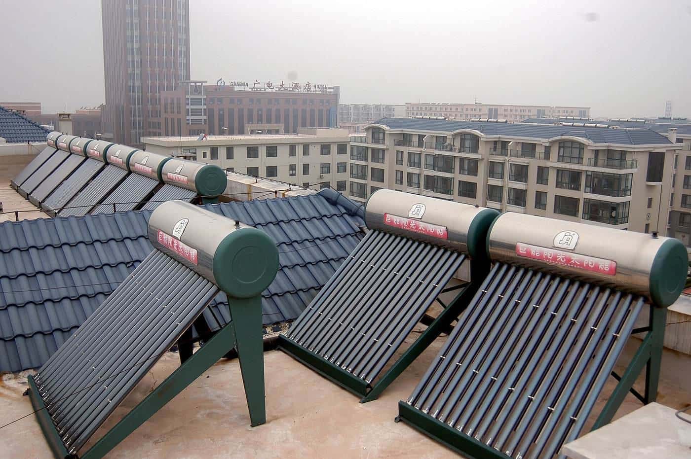 Evacuated-tube solar water heaters on a tiled roof